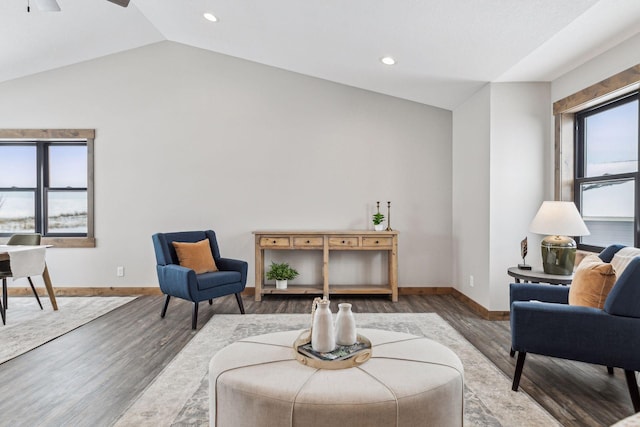 sitting room with dark wood-type flooring, lofted ceiling, and ceiling fan