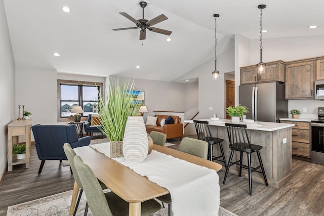 dining space featuring ceiling fan, high vaulted ceiling, and dark hardwood / wood-style flooring