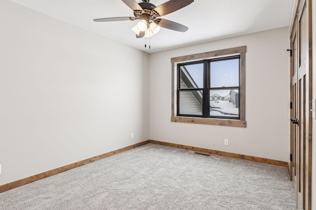 unfurnished room featuring carpet floors and ceiling fan