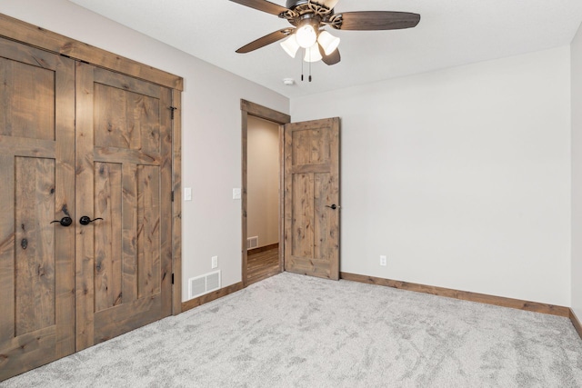 unfurnished bedroom featuring carpet flooring and ceiling fan