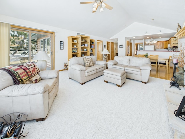 living area featuring high vaulted ceiling, a ceiling fan, and light colored carpet