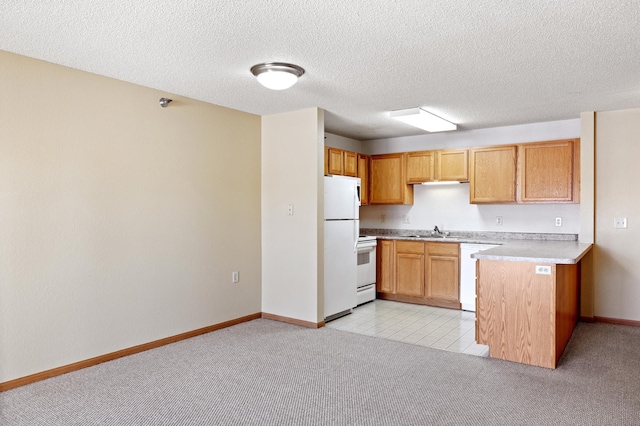 kitchen featuring white appliances, a textured ceiling, sink, and light colored carpet