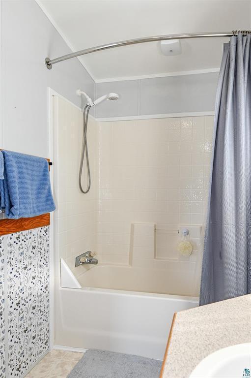 bathroom featuring shower / bath combination with curtain and vanity