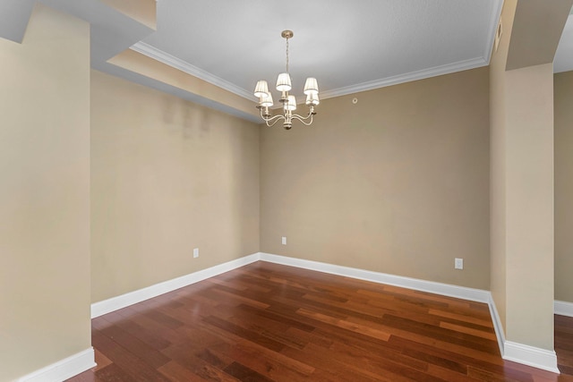 spare room featuring baseboards, an inviting chandelier, crown molding, and dark wood-style flooring