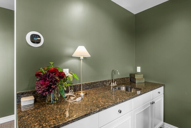 interior space with baseboards and a sink