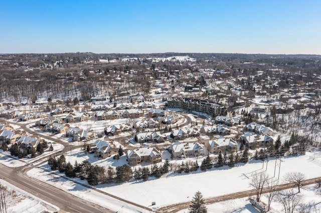 snowy aerial view with a residential view