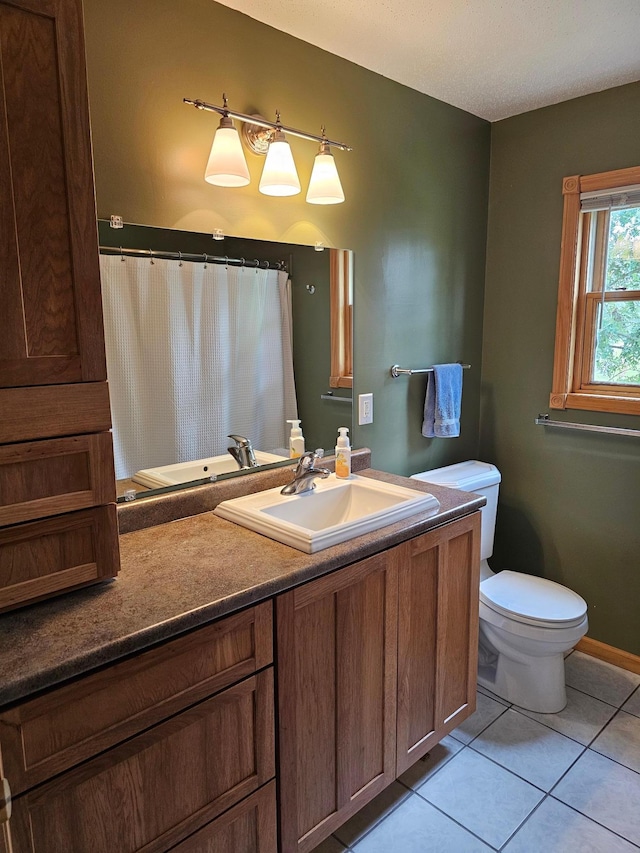 bathroom featuring vanity, tile patterned flooring, and toilet