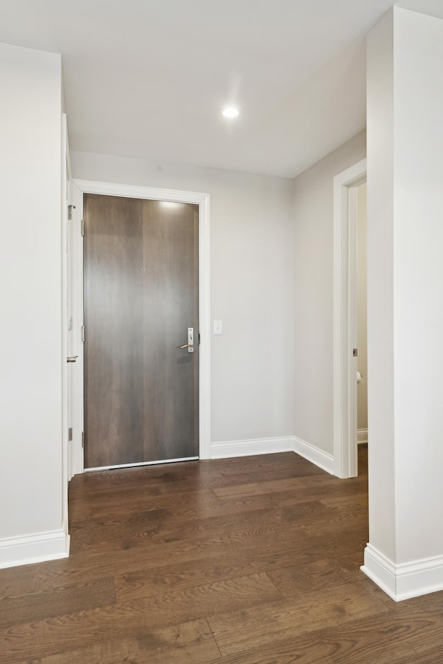 foyer featuring recessed lighting, baseboards, and wood finished floors