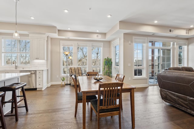 dining room with visible vents, baseboards, dark wood finished floors, and recessed lighting