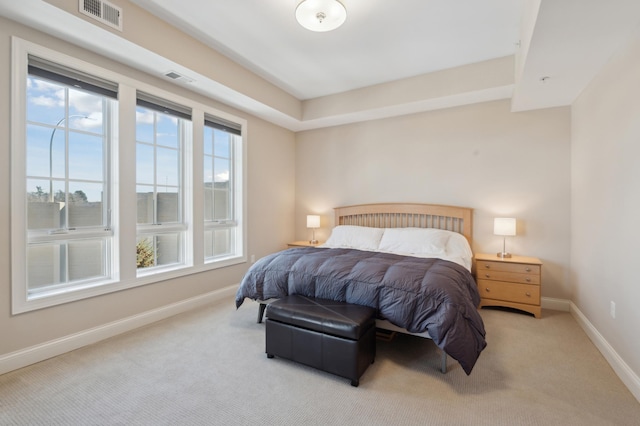 carpeted bedroom featuring visible vents and baseboards