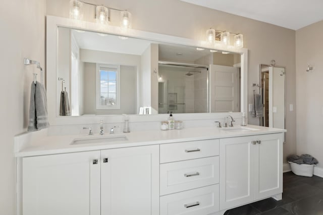 full bathroom with double vanity, a sink, and a shower stall