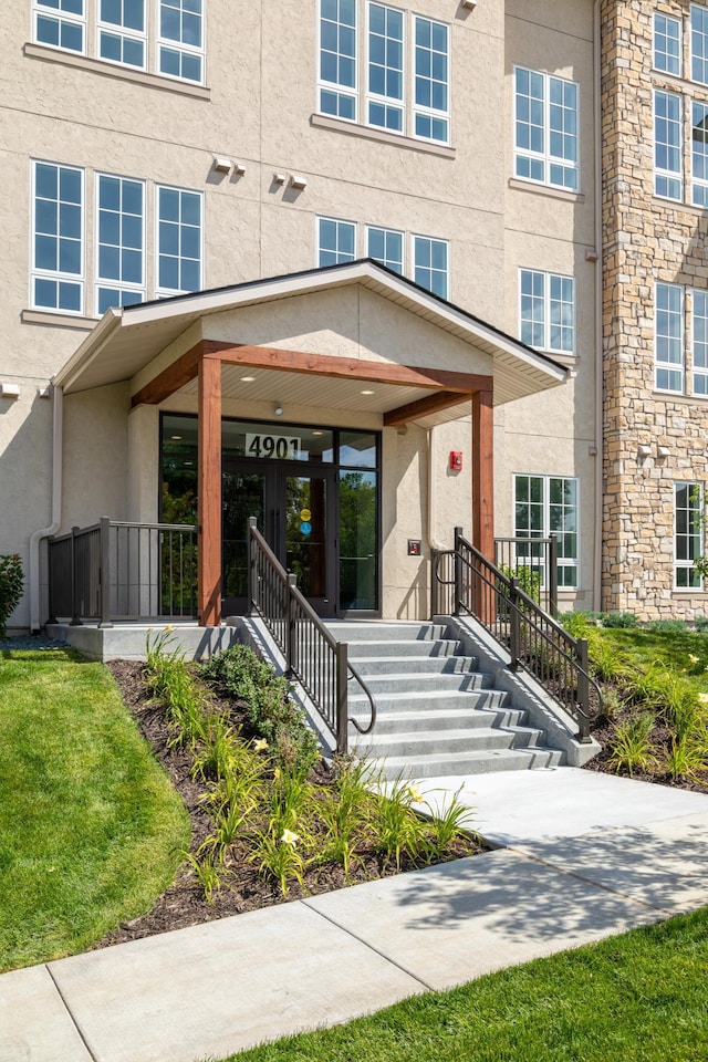 entrance to property featuring stucco siding