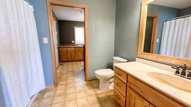 bathroom with toilet, tile patterned flooring, and vanity