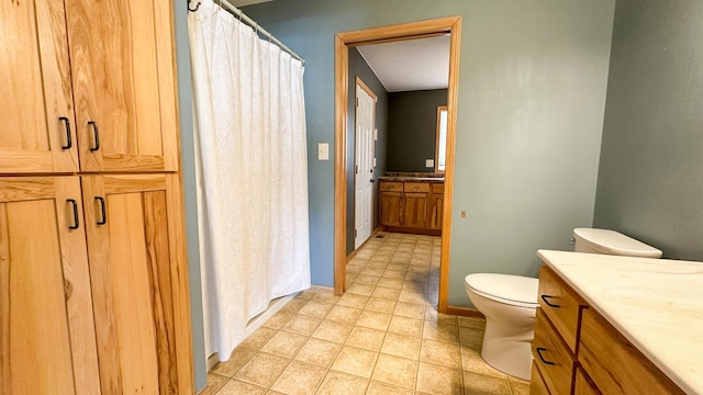 bathroom with tile patterned floors, toilet, and vanity