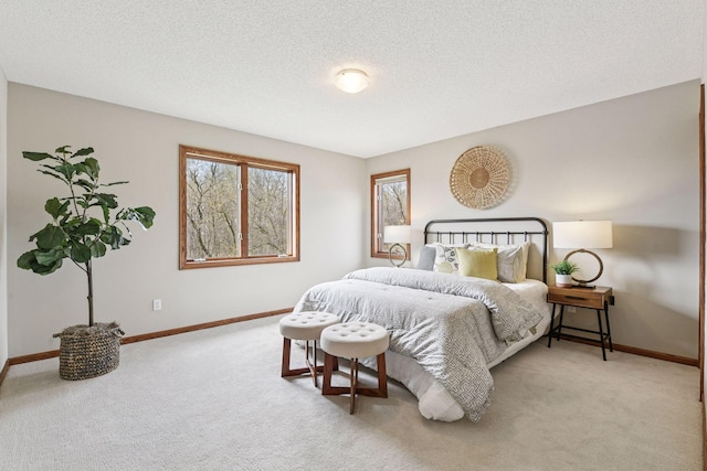 bedroom with baseboards, carpet flooring, and a textured ceiling