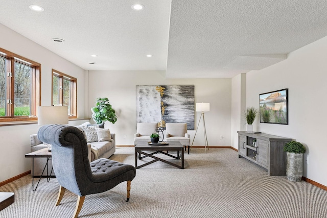 living room featuring a textured ceiling, baseboards, light colored carpet, and recessed lighting