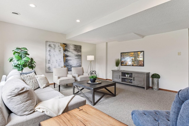 living area with carpet flooring, recessed lighting, baseboards, and a textured ceiling