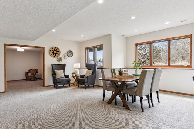 dining space featuring recessed lighting, baseboards, light colored carpet, and a textured ceiling
