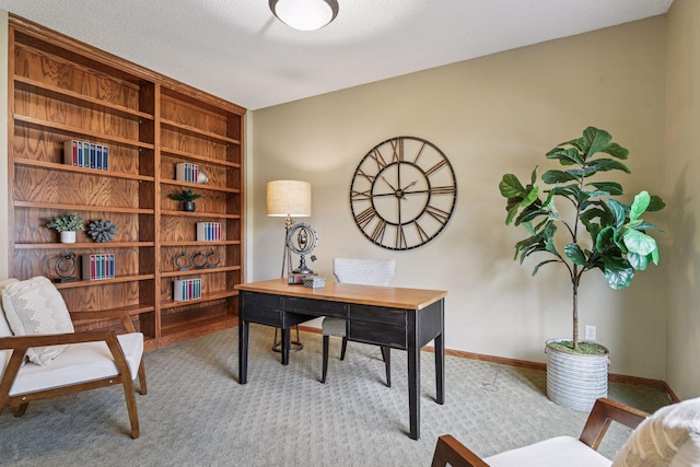 home office with carpet floors, baseboards, and built in features