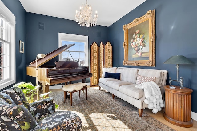 sitting room with a chandelier and wood finished floors