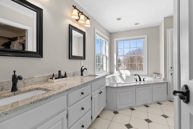 full bath featuring a bath, double vanity, and a sink