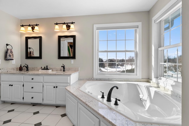 bathroom featuring a sink, a garden tub, and double vanity