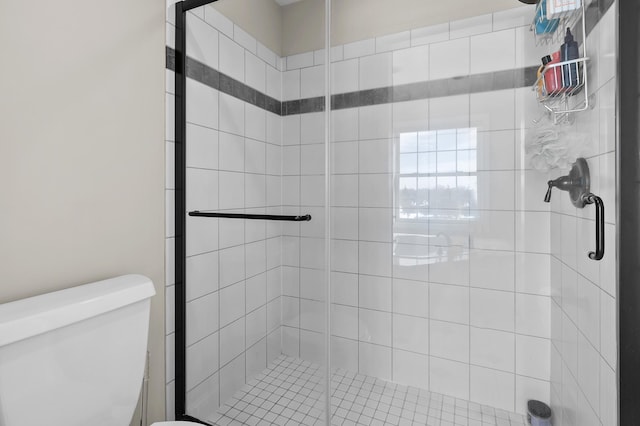 full bathroom with a shower stall and toilet