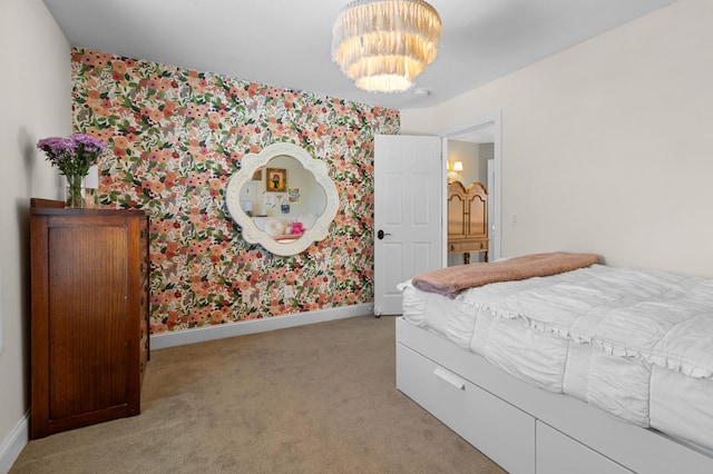 bedroom with baseboards, light carpet, an inviting chandelier, and wallpapered walls