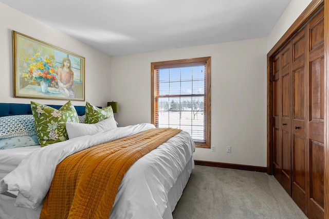 bedroom featuring light carpet, a closet, and baseboards