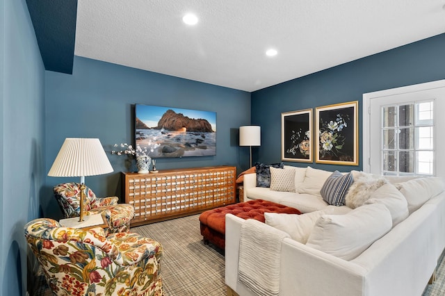 carpeted living room featuring recessed lighting and a textured ceiling