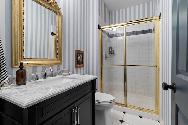 full bathroom with toilet, a stall shower, vanity, and wallpapered walls