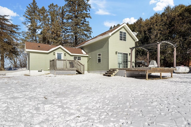 snow covered property featuring a wooden deck and a pergola