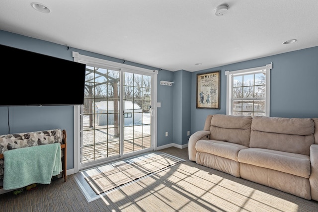 living room featuring carpet floors and baseboards