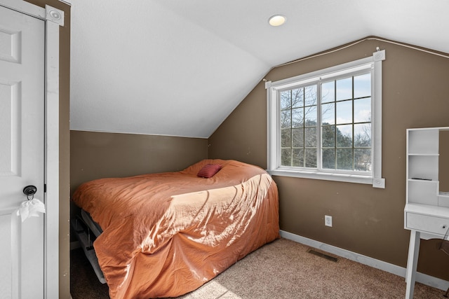 bedroom featuring lofted ceiling, carpet, baseboards, and visible vents