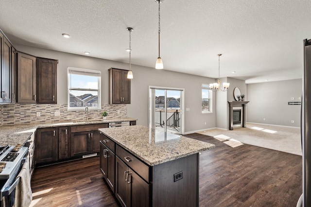 kitchen featuring decorative backsplash, dark brown cabinetry, and a sink