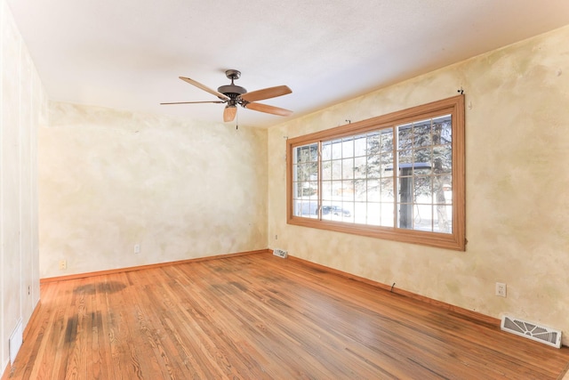 empty room featuring ceiling fan and wood-type flooring