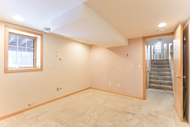 basement featuring light colored carpet