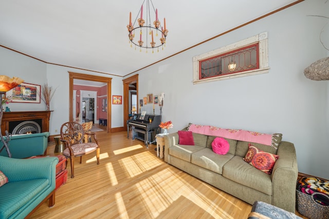 living room with hardwood / wood-style flooring, crown molding, and a chandelier