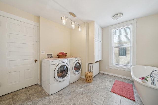 laundry area featuring radiator and washing machine and clothes dryer