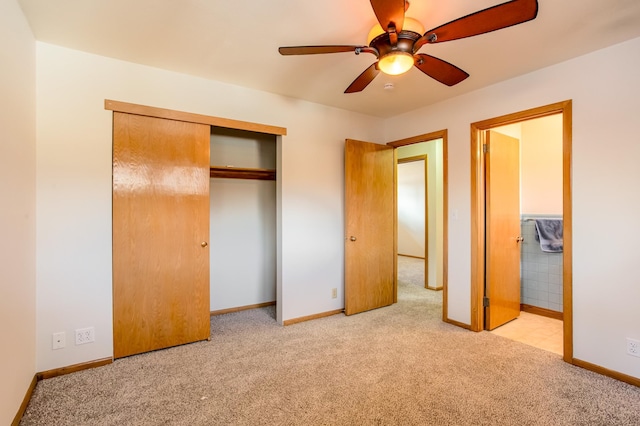 unfurnished bedroom with ensuite bathroom, baseboards, a closet, and carpet floors