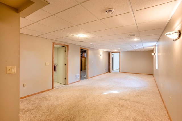 basement with visible vents, baseboards, and carpet