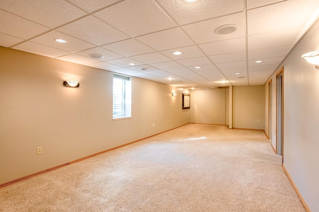 basement with baseboards and light carpet