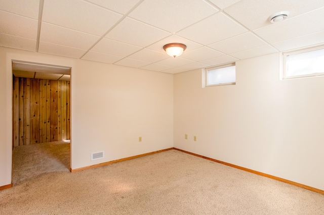 below grade area with a wealth of natural light, visible vents, and carpet