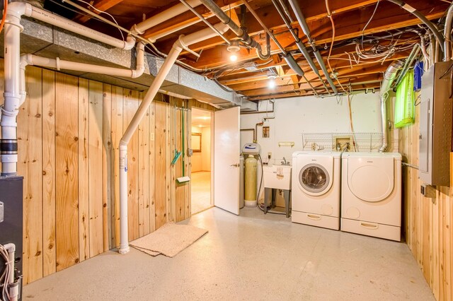 unfinished basement featuring washer and clothes dryer and a sink