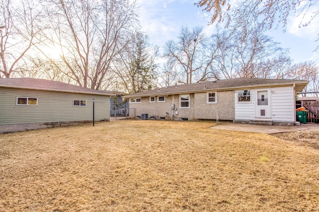 back of house with a yard, a patio, central AC, and fence