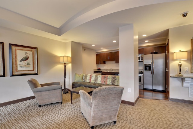 living area with light carpet, visible vents, baseboards, and recessed lighting