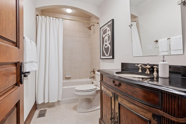 bathroom featuring toilet, vanity, visible vents, tile patterned floors, and shower / bath combo