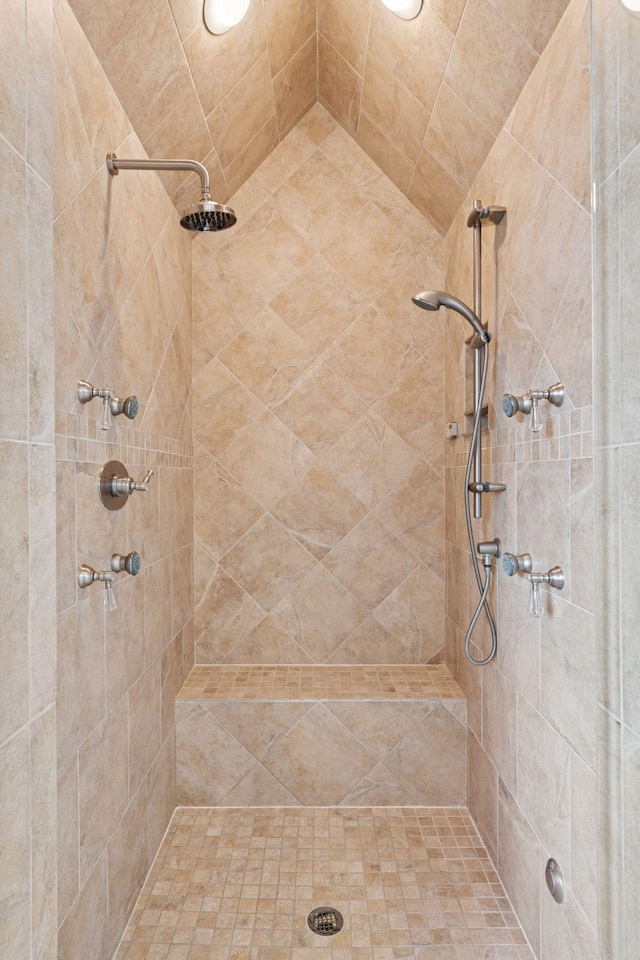 full bath with a tile shower