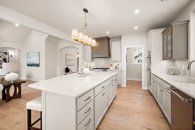 116 Spring Farm Rd, North Oaks, MN 55127 - kitchen featuring a sink, dishwasher, premium range hood, decorative backsplash, and arched walkways