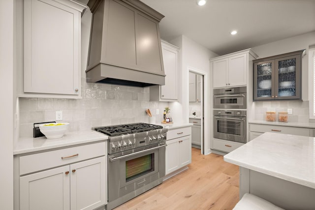 116 Spring Farm Rd, North Oaks, MN 55127 - kitchen featuring stainless steel appliances, light countertops, light wood-style flooring, tasteful backsplash, and recessed lighting
